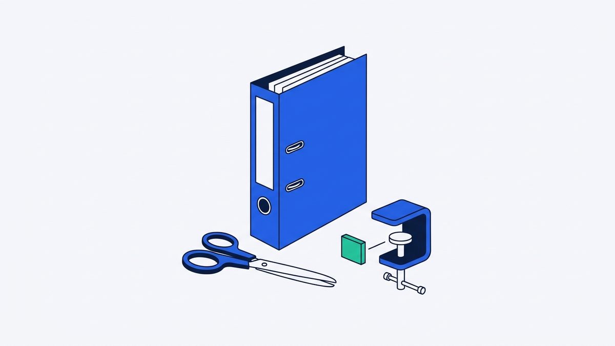 a thick paper binder, a pair of scissors, and a desk clamp